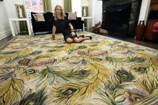 Fashion designer Nanette Lepore lounges on a peacock-themed carpet in her home in New York's Greenwich Village.