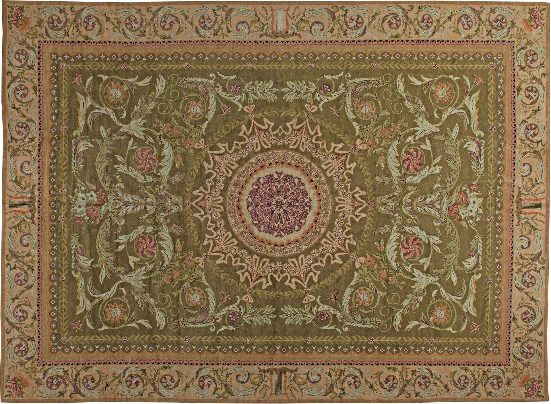 An oversized antique Savonnerie rug in moss green. Circa 1900’s, France. Rug size: 16’3” x 21’9”