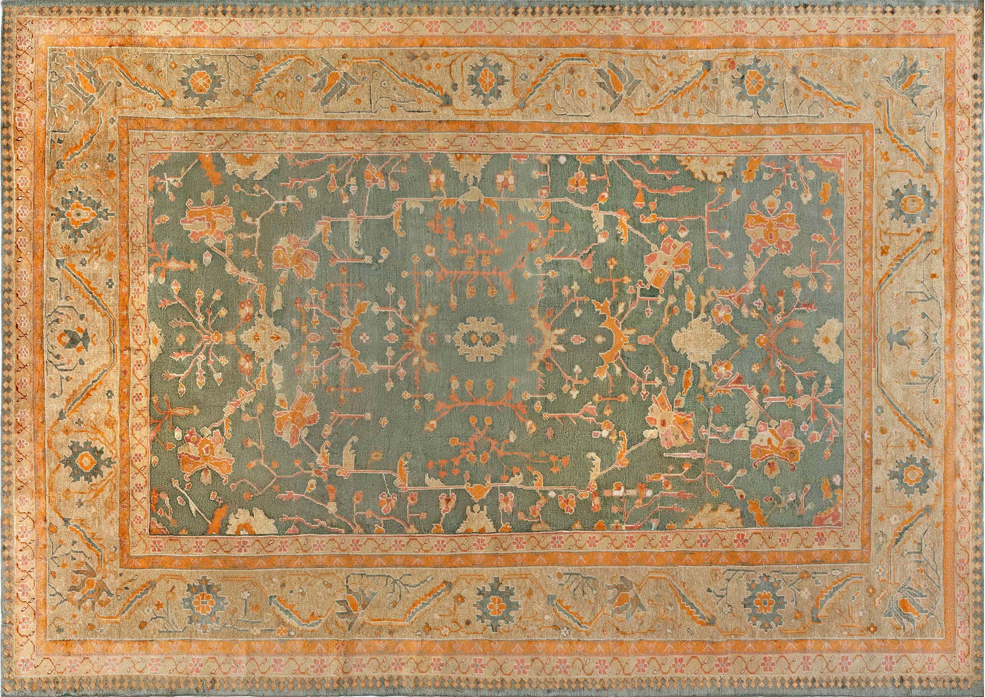 An antique Oushak rug in myrtle green. Circa 1930’s, Turkey. Rug size: 10’6” x 14’8”
